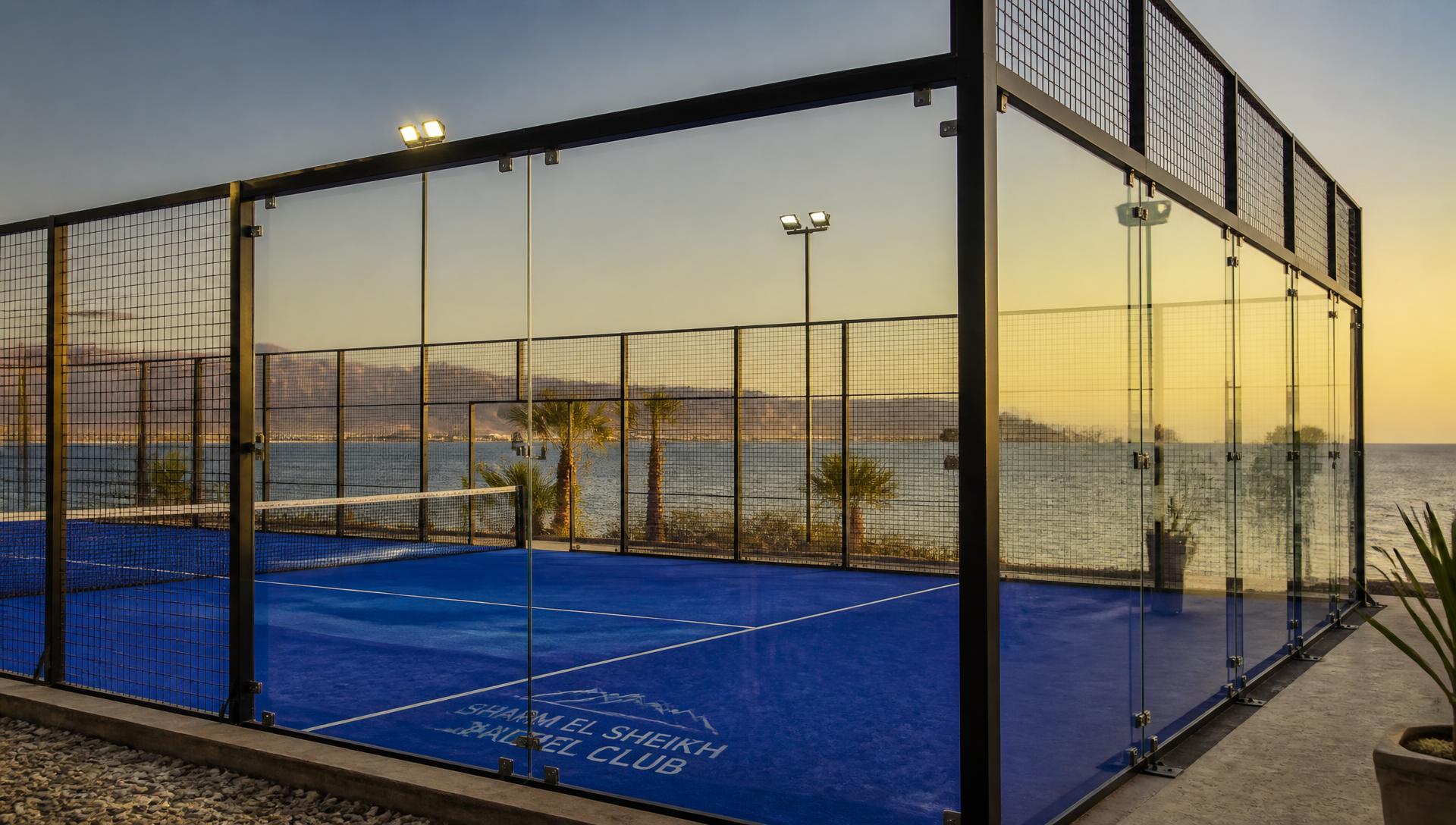 Glass padel court beside the Red Sea in Sharm El Sheikh at sunset